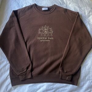 Brown embroidered "peace on earth" crewneck from Palo Santa Studios!